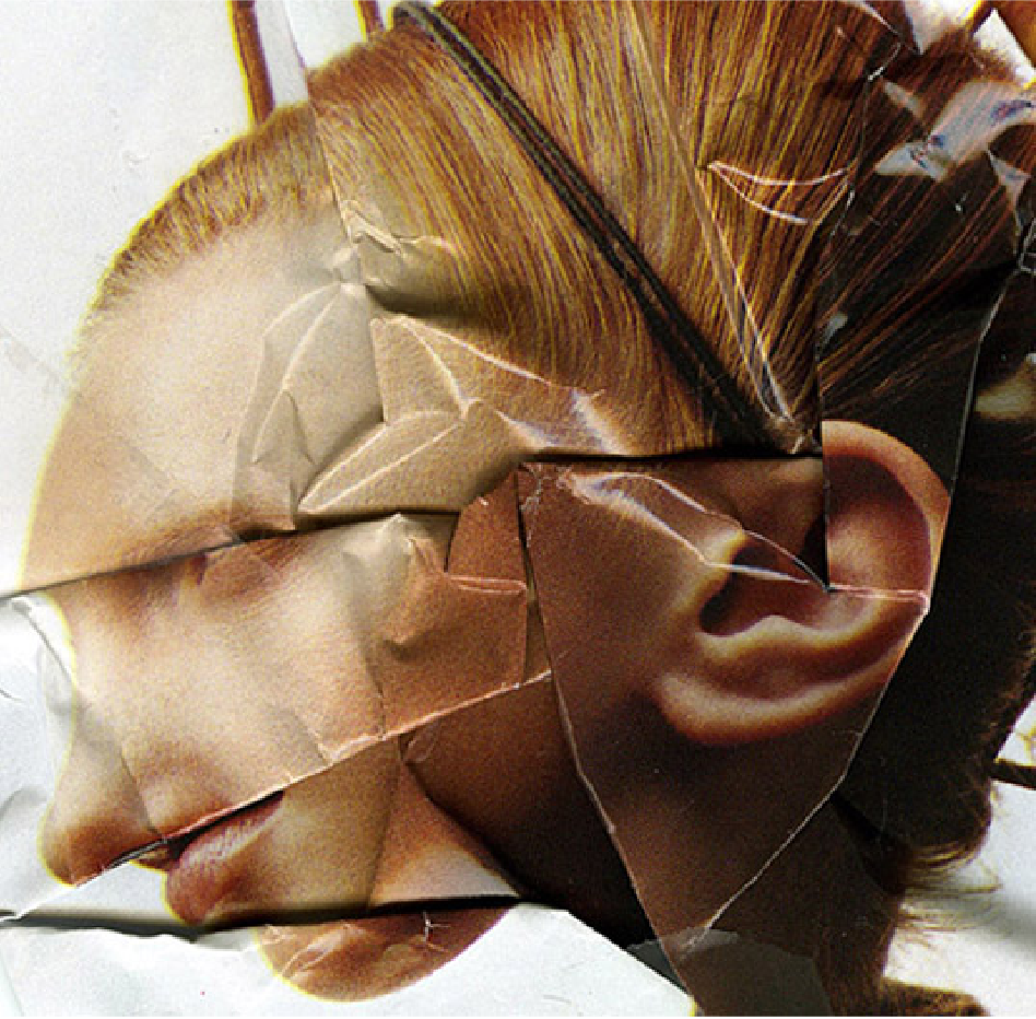 Scan of a folded fashion magazine page displaying the portrait of a blond hair person looking to the left. The folds are messing with the facial features hiding the eyes, nose and mouth are smashed together. A very large ear is visible.