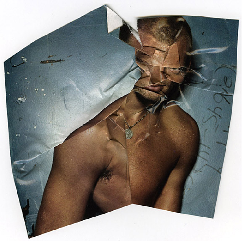 Scan of a folded fashion magazine page displaying the chest and head of man The folds are messing with the facial and body features hiding the right eyes, smashing the nose and mouth, making the face having a threatening stare.